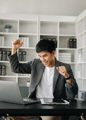 Asian businessman are delighted and happy with the work they do on their tablet, laptop and taking notes at the modern office.