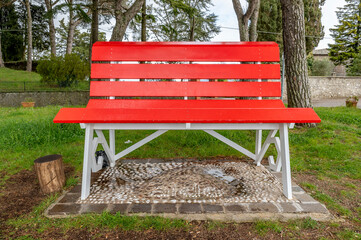 A giant red wooden bench in a city park in Montefiascone, Italy