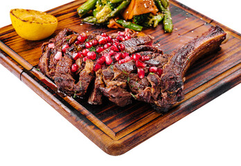 Sliced grilled pork steak with pomegranate seeds and asparagus