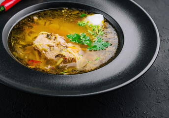 Chicken noodle soup in black plate