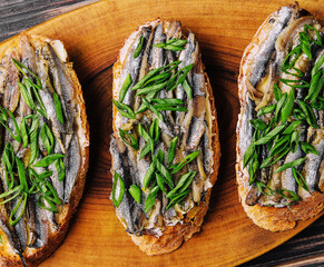 Top view pickled anchovies with spring onions