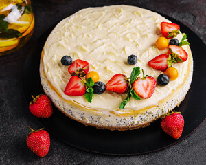 cheesecake with poppy seeds decorated with fresh strawberries