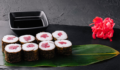 Maki rolls with tuna on black stone
