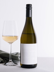 Bottle and glass of white wine isolated on white background