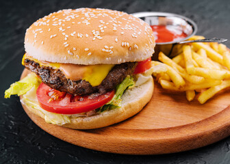 Fresh burger with french fries on wood