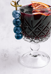 Glass of hot mulled wine with spices