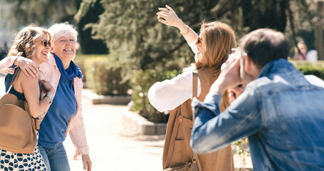 Man shooting mature women dancing in park