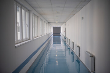 Empty corridor at public hospital, Public building corridor area. Hospital hallway with rooms....