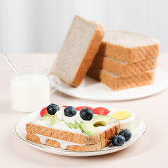 Scene with toast bread with fruit and milk, healthy breakfast, indoor kitchen photography
