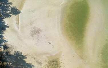 Wave with white foamy coastline  beach. Waves across untouched shore  Soft waves of blue sea and sand on summer Beautiful clean sandy beach wide High angle shot aerial.