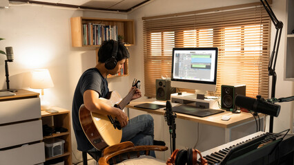 Asian man making music at home studio