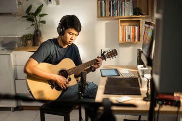 Asian man making music at home studio