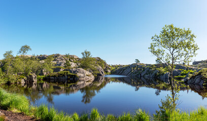Fototapeta na wymiar Panorama of a beautiful pond on the trail to the Preikestolen near Stavanger, Norway