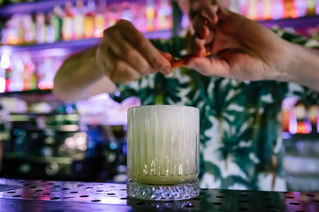 man hand bartender making cocktail in glass on the bar counter