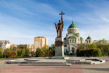 Monument to the Holy Prince Vladimir against the backdrop of the Vladimir Cathedral in Astrakhan....