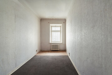 Empty room without furniture in an old apartment building. Unrenovated empty room