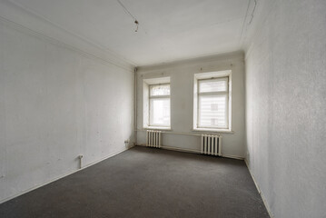 Empty room without furniture in an old apartment building. Unrenovated empty room
