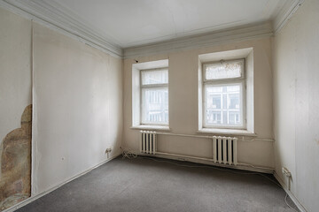 Empty room without furniture in an old apartment building. Unrenovated empty room