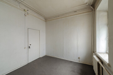 Empty room without furniture in an old apartment building. Unrenovated empty room