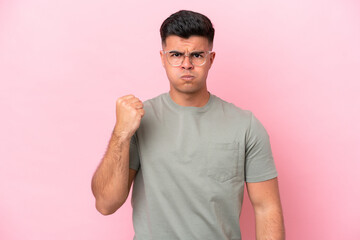 Young caucasian handsome man isolated on pink background with unhappy expression