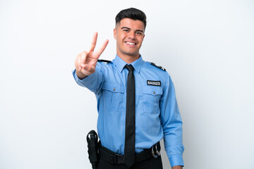Young police caucasian man isolated on white background smiling and showing victory sign