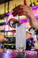 man bartender making cold gin tonic cocktail in bar