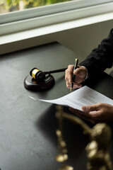 Lawyers who work with hammers and scales or read law books in the office office for consulting...
