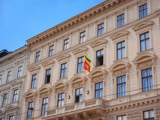 Fototapeta na wymiar Flag of Sri Lanka on the facade of an old house. Cityscape views old city of one of Europe's most beautiful town- Vienna. Summer Travel to capital of Austria. details of the facades of beautiful old