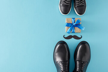 Stylish gift concept for Father's Day. Top view flat lay of gift box black mustache trendy shoes father and child on light blue background with empty space for text or advert