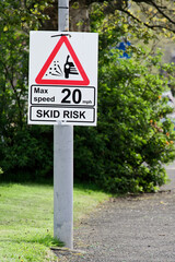 Skid risk road speed limit safety sign