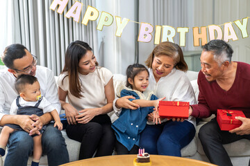 Portrait of happy love asian big family father and mother with asian baby and little girl happy birthday, party, celebration, cake, surprise, grandfather with grandmother smiling together.Family party