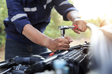 Automobile mechanic repairman hands repairing a car engine automotive workshop with a wrench, car service and maintenance,Repair service.