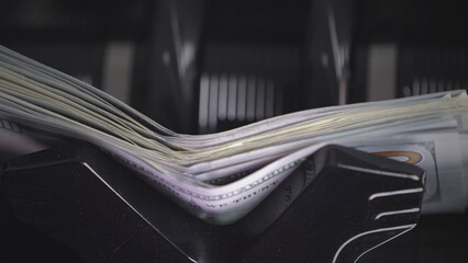 Money counting equipment for paper money calculation. Automatic mechanism for bank financial operations. Currency exchange of one hundred usd. Closeup currency counting machine counting dollar bills