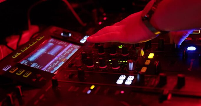 Nightclub, nightlife concept. DJ hands mixing DJ remote.