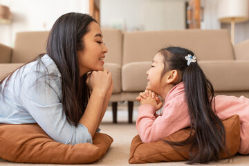 Happy Japanese Mom And Daughter Talking Enjoying Moment At Home