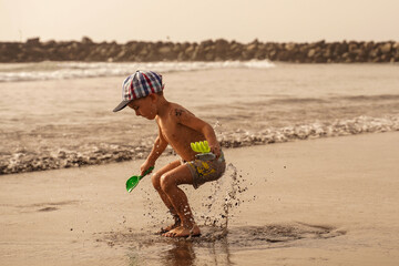 The child jumped on the seashore. A boy in flight on a summer vacation