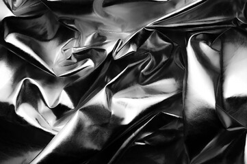 crumpled metallic reflector black and white background texture 