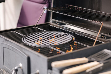 Photo of empty BBQ grill. The fire is burning