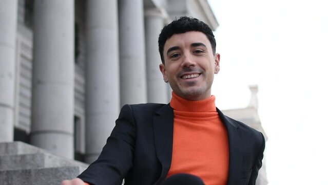Close up portrait of one handsome business happy young man smiling looking at camera standing outdoors. Front view of isolated cheerful caucasian male face