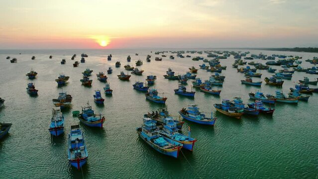Aerial view of Mui Ne fishing village in sunset sky with hundreds of boats anchored to avoid storms, this is a beautiful bay in central Vietnam