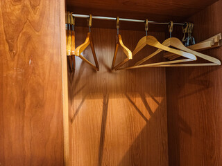 wooden hangers is an empty open cabinet