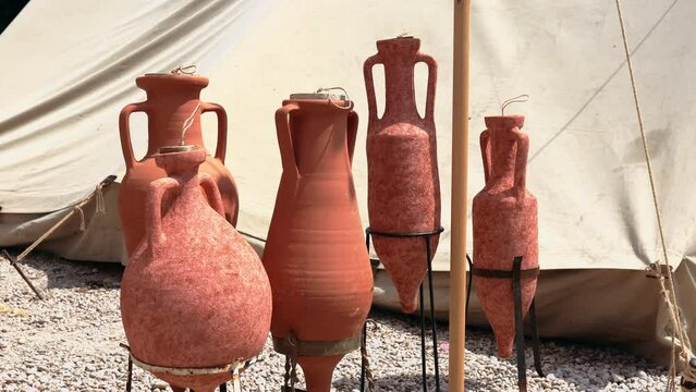 Clay wine amphora in military camp of Roman legionaries, handmade wine jug of imperial era, clay pottery and crockery of Roman soldiers in camp, historical art and culture of military legion