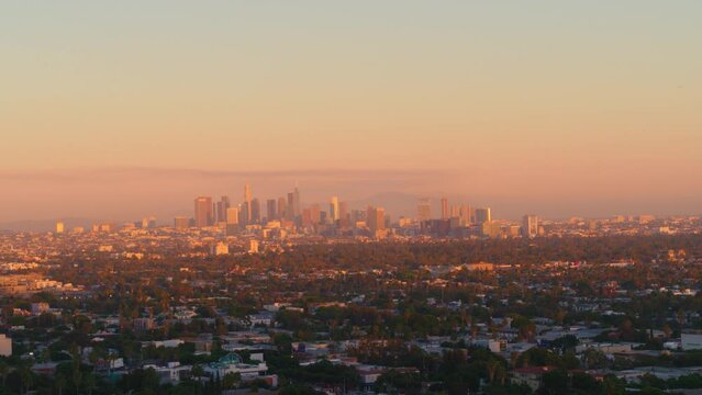 Aerial Panning Shot Of Cityscape Against Orange Sky During Sunset - Los Angeles, California
