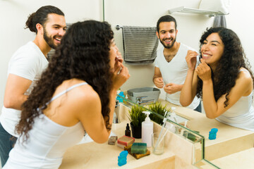 Cheerful couple using dental floss together