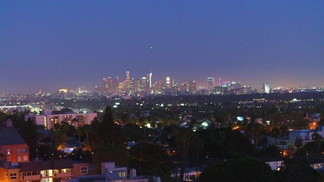 Aerial Panning Shot Of Illuminated Cityscape With Skyscrapers In Background At Night - Los Angeles, California