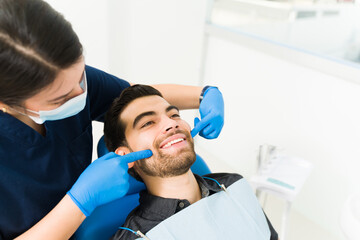 Attractive young man with a big smile at the dentist