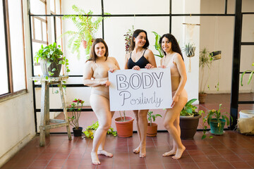 Smiling beautiful women promoting body acceptance and self love