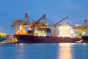 Cargo ship at dock, port or harbor. To loading cargo container, work with crane. Concept of...