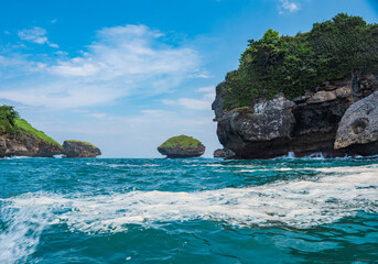 Rock formation on the ocean near the Tanjung Kasap or Cape Kasap, Pacitan, Indonesia. Taken from a moving boat.