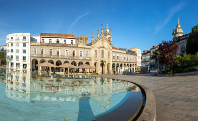 sunrise view of Praca da Republica in the historical center of Braga, Portugal with reflection in fountain.